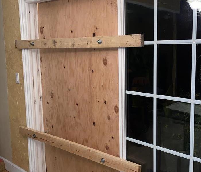 SERVPRO boarded up window with plywood