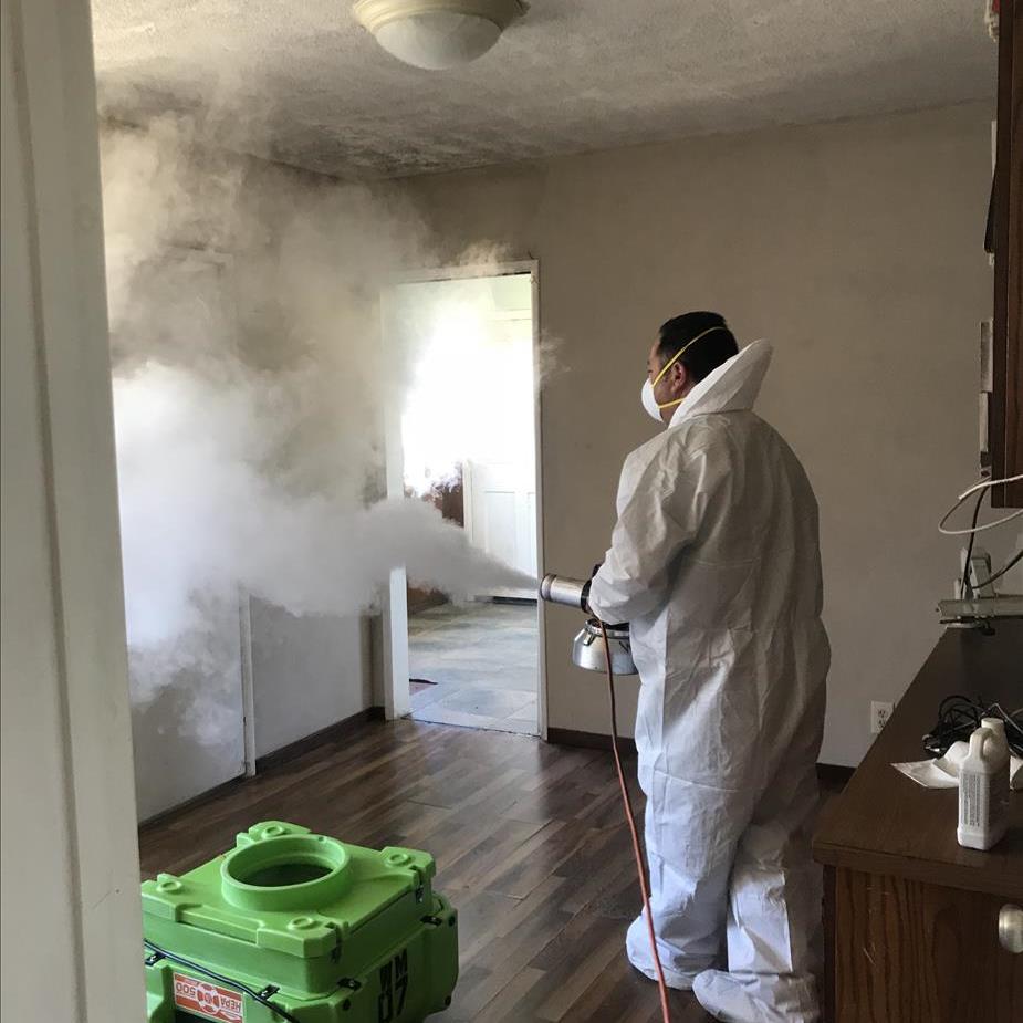 SERVPRO of Westminster worker with white suit holding fogging machine 