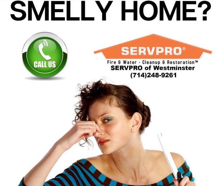 Woman pinching her nose, white background, SERVPRO logo