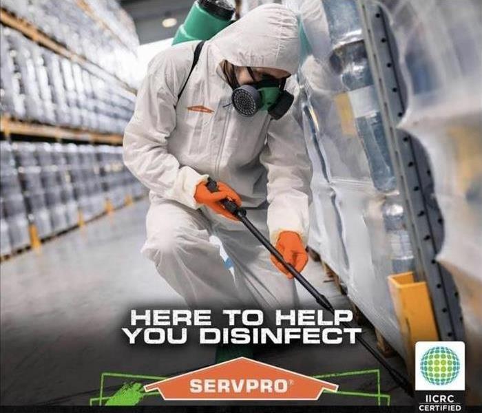 SERVPRO worker wearing suit and disinfecting 